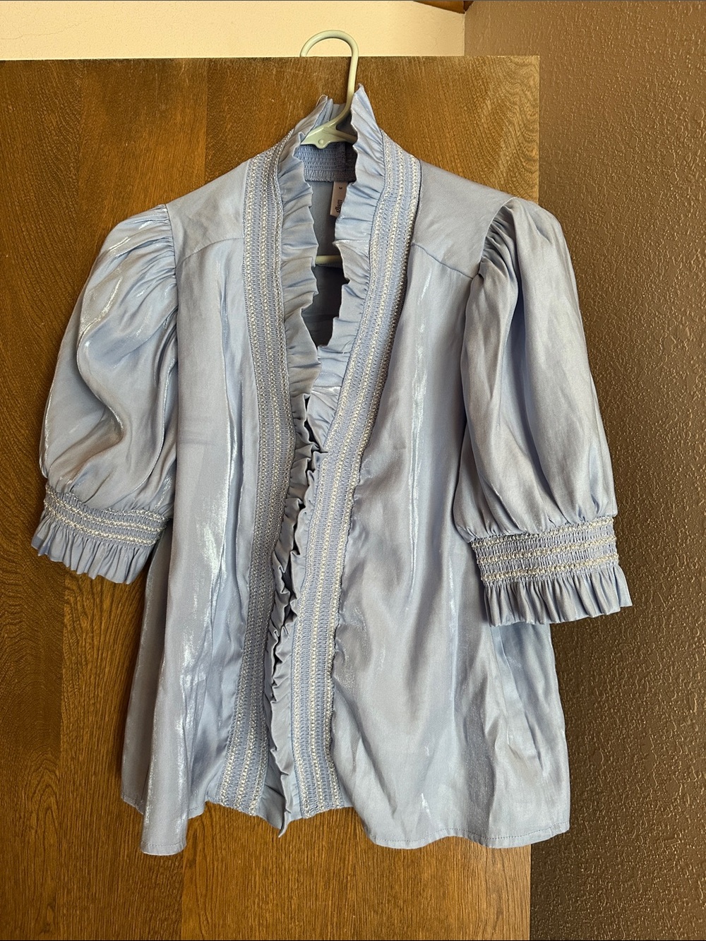 Shiny blue ruffle blouse